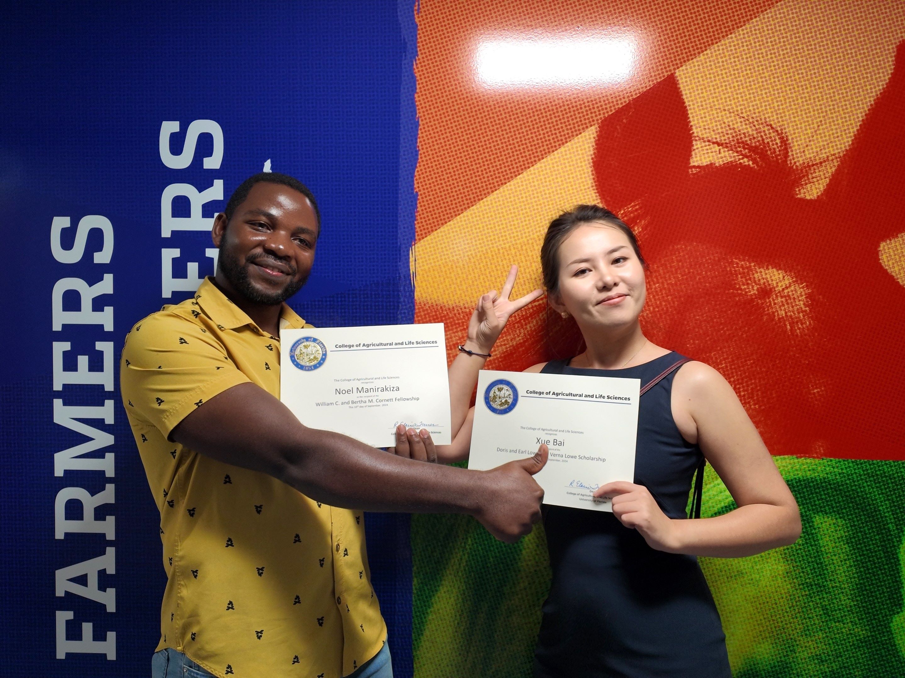 two people holding paper